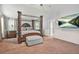 Spacious main bedroom with a four-poster bed, plush carpet, and a serene ambiance at 364 Mossycup Dr, Fairburn, GA 30213
