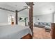 Spacious main bedroom featuring a four-poster bed, seating area, and a view into the main bathroom at 364 Mossycup Dr, Fairburn, GA 30213