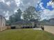 Back exterior of the home, displaying the large backyard with lush green grass at 3845 Pebble Beach Dr, Atlanta, GA 30349