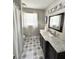 Bathroom with a stylish vanity with marble countertop and decorative patterned floors at 3845 Pebble Beach Dr, Atlanta, GA 30349
