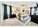 A staged bedroom with neutral tones featuring a ceiling fan, carpet, and plenty of natural light at 3845 Pebble Beach Dr, Atlanta, GA 30349