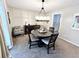 Cozy dining room featuring neutral wall colors and a modern chandelier over a wood table at 3845 Pebble Beach Dr, Atlanta, GA 30349
