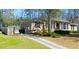 Charming brick home with well-manicured lawn, driveway, and lush landscaping at 3845 Pebble Beach Dr, Atlanta, GA 30349