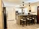 Kitchen featuring white cabinetry, stainless steel appliances, and a breakfast bar with seating at 3845 Pebble Beach Dr, Atlanta, GA 30349