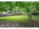 Expansive backyard with a lush lawn and a wooden fence surround at 877 Mclendon Dr, Scottdale, GA 30079