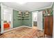 Bedroom with hardwood floors, storage shelves and a view of an ensuite bathroom at 877 Mclendon Dr, Scottdale, GA 30079