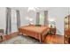 Bedroom featuring hardwood floors, natural light, and a spacious bed at 877 Mclendon Dr, Scottdale, GA 30079