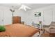 Bright bedroom with hardwood floors, dresser, TV and comfortable chair at 877 Mclendon Dr, Scottdale, GA 30079