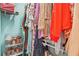 Brightly lit walk-in closet filled with shoes and colorful hanging clothes at 877 Mclendon Dr, Scottdale, GA 30079