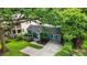 Quaint home with a lush front yard, complemented by mature trees at 877 Mclendon Dr, Scottdale, GA 30079