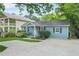 Charming home with well-manicured front yard with blossoming flowers at 877 Mclendon Dr, Scottdale, GA 30079