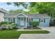 Charming home exterior with manicured landscaping, beautiful flowers and a welcoming front door at 877 Mclendon Dr, Scottdale, GA 30079