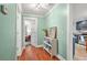 Hallway featuring hardwood floors leading to the bedroom and kitchen at 877 Mclendon Dr, Scottdale, GA 30079