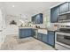 Stylish kitchen boasts custom cabinetry, stainless appliances, a farmhouse sink and ample countertop space at 877 Mclendon Dr, Scottdale, GA 30079