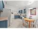 Spacious kitchen with stainless steel appliances, tiled floors, shaker cabinets and eat-in dining area at 877 Mclendon Dr, Scottdale, GA 30079