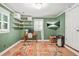 Bright office space with open shelving, wooden desk, and mounted flatscreen television at 877 Mclendon Dr, Scottdale, GA 30079