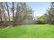 A serene backyard with a lush green lawn and a wooden fence creates a private outdoor space at 1460 Chamirey Sw Dr, Marietta, GA 30008