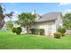 Back exterior of a light colored home with green grassy area and mature landscaping in a fully fenced yard at 1460 Chamirey Sw Dr, Marietta, GA 30008