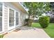 A concrete patio leads to the door and windows, and is surrounded by manicured landscaping at 1460 Chamirey Sw Dr, Marietta, GA 30008
