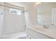 Bright white bathroom with tub, shower, and vanity with sink at 1460 Chamirey Sw Dr, Marietta, GA 30008