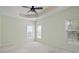 Light-filled bedroom featuring a ceiling fan and neutral carpeting at 1460 Chamirey Sw Dr, Marietta, GA 30008