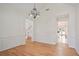 Dining room boasts hardwood floors and classic trim adjacent to the stairs and kitchen at 1460 Chamirey Sw Dr, Marietta, GA 30008