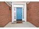 Bright blue front door framed by white trim, sidelights, and classic brick facade at 1460 Chamirey Sw Dr, Marietta, GA 30008