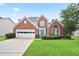 Charming two-story brick home with a well-manicured lawn and a bright blue front door at 1460 Chamirey Sw Dr, Marietta, GA 30008