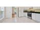 Bright kitchen featuring white cabinets, stainless steel appliances, and access to dining room at 1460 Chamirey Sw Dr, Marietta, GA 30008