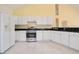 Spacious kitchen features white cabinets, stainless steel appliances, and tiled flooring at 1460 Chamirey Sw Dr, Marietta, GA 30008