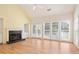 Spacious living room features fireplace, hardwood floors, many windows, and sliding door at 1460 Chamirey Sw Dr, Marietta, GA 30008