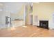 Open-concept living room features fireplace, hardwood floors, many windows, and kitchen view at 1460 Chamirey Sw Dr, Marietta, GA 30008
