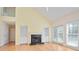 Open living room featuring fireplace, hardwood floors, many windows, and a staircase at 1460 Chamirey Sw Dr, Marietta, GA 30008