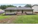 Home's backyard featuring a small wooden deck and a well-maintained lawn at 2784 Oxford Dr, Decatur, GA 30034