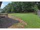 View of a large backyard with green grass and a partial wooden deck at 2784 Oxford Dr, Decatur, GA 30034