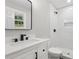 Updated bathroom featuring walk-in shower, white tile and dark hardware at 2784 Oxford Dr, Decatur, GA 30034
