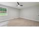 Bedroom featuring hardwood floors, light grey walls, a window and modern ceiling fan at 2784 Oxford Dr, Decatur, GA 30034