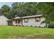 Charming single-story home with a well-manicured lawn, gray garage door, and light blue front door at 2784 Oxford Dr, Decatur, GA 30034