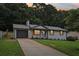 Inviting single-story home with gray garage, concrete driveway, and meticulously landscaped front yard at 2784 Oxford Dr, Decatur, GA 30034