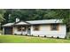 Charming single-story home featuring a garage, wooden shutters, and well-maintained landscaping at 2784 Oxford Dr, Decatur, GA 30034