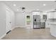 Bright, open kitchen features stainless steel appliances and white cabinets with light hardwood flooring at 2784 Oxford Dr, Decatur, GA 30034