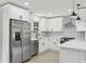 Modern kitchen featuring stainless steel appliances, white cabinets, and tile backsplash at 2784 Oxford Dr, Decatur, GA 30034