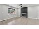 Living room showcasing wood flooring, a black fireplace, and large picture window at 2784 Oxford Dr, Decatur, GA 30034