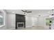 Open-concept living area with a modern fireplace and view of kitchen and back deck at 2784 Oxford Dr, Decatur, GA 30034