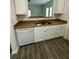 Updated kitchen featuring a stainless steel sink, tile countertops, and modern white cabinets at 3609 Ginnis Rd, Atlanta, GA 30331