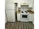 Bright kitchen featuring white appliances, cabinets, and new flooring at 3609 Ginnis Rd, Atlanta, GA 30331