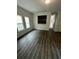 Open-concept living room with wood-look floors and plenty of natural light from large windows at 3609 Ginnis Rd, Atlanta, GA 30331