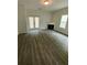 Living room featuring modern wood floors, a cozy fireplace, and French doors to the backyard at 3609 Ginnis Rd, Atlanta, GA 30331