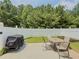 Fenced backyard featuring a patio with a grill and a table with chairs perfect for outdoor dining at 557 Pringle Dr, Suwanee, GA 30024