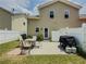 Exterior view of the backyard showing a patio with outdoor furniture, a grill, and a well-maintained lawn at 557 Pringle Dr, Suwanee, GA 30024
